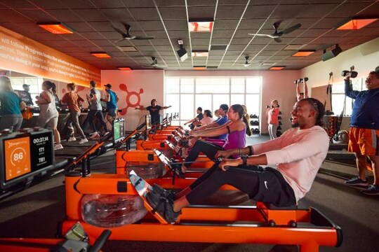 Compact fitness studio interior with treadmills, rowers and strength equipment